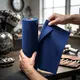 Tearing off Xzone microfiber cloth from the roll in a motorcycle workshop